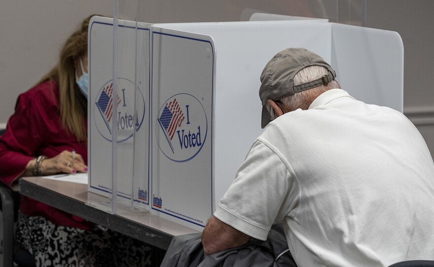 Voters cast ballots during early voting in Fairfax, Va., on Sept. 18, 2020. During the first presidential debate, President Trump would not commit to refraining from declaring victory until the election has been independently certified.