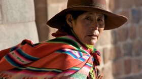Latin woman sitting. "When Worlds Collide" examines how the New World radically transformed the Old World, including the impact of advanced agricultural and textile practices of the indigenous society that existed in Latin America prior to the Spanish “conquest.”