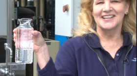 Marsi Steirer with the San Diego Public Utilities Department holds a flask of recycled wasterwater that she says is cleaner than what comes out of your tap. 