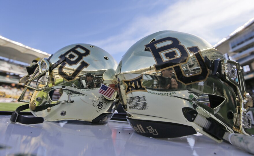 Baylor University football helmets on shown the field after an NCAA game in Waco, Texas, in 2015. A new lawsuit accuses Baylor football players of drugging and gang-raping young women as part of a hazing or bonding ritual.