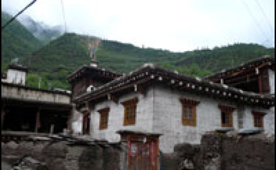 The village's sturdy houses are built along traditional lines, but residents say climate change has affected the patterns of life in Mingyong village.