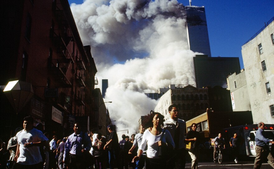 Pedestrians on Church Street run from falling debris as the South Tower of the World Trade Center collapses at 9:59 a.m.