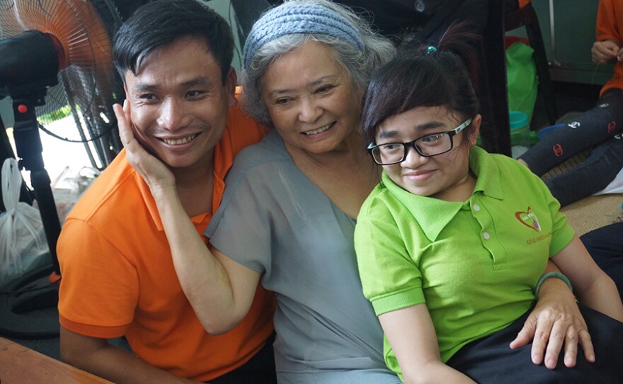 Tran To Nga sits with victims of Agent Orange at the War Remnants Museum in Ho Chi Minh City, Vietnam.