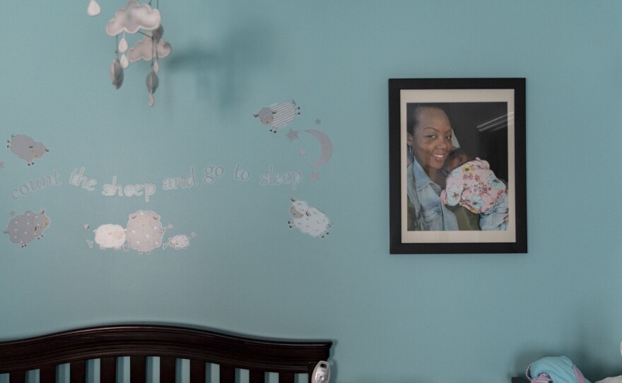 A large, framed photograph of newborn Soleil and mother Shalon hangs in Soleil's nursery. Shalon painted the nursery light blue shortly before Soleil was born.