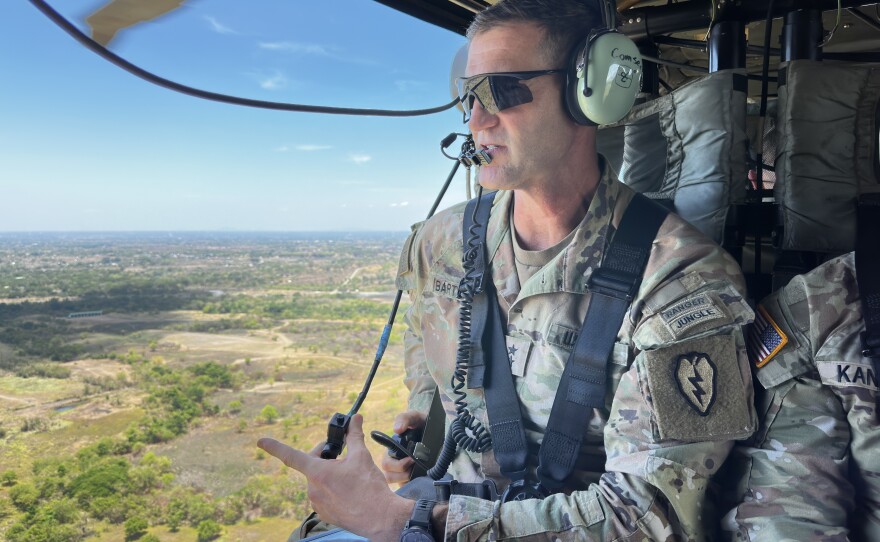 The commander of the U.S. Army's 25th Infantry Division, Maj. Gen. James B. Bartholomees III, scans the terrain of central Luzon island from a Black Hawk helicopter.