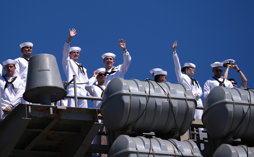 Sailors wave aboard the USS Abraham Lincoln aircraft carrier as it returns to Naval Air Station North Island after deployment Thursday, Oct. 8, 2026, in Coronado, Calif.