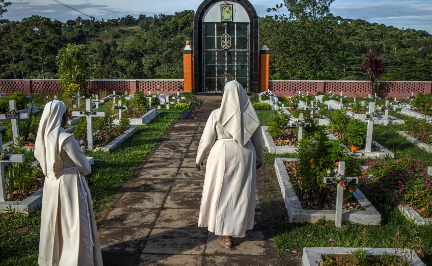 Sister Jane Francis Nakafeero, superior general of the Little Sisters of St. Francis, walks with another nun at the cemetery in Nkokonjeru, Uganda, where members of the order are laid to rest.