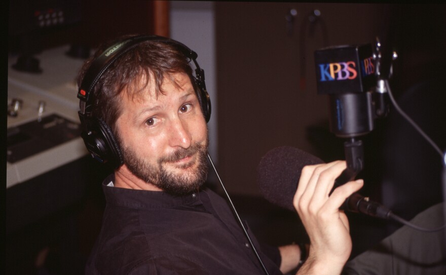 Thomas Fudge poses in front of the KPBS microphone in this undated photograph. Fudge is retiring after 30 years at KPBS.