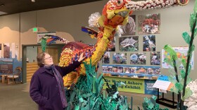 In her gallery in Bandon, Ore., Angela Haseltine Pozzi stands next to an enormous sea dragon sculpted from plastics found on Oregon's beaches that are normally famous for being pristine and wild.
