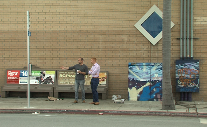 Hillcrest Business Association President Ben Nicholls, left, gestures to trash littering a bus stop in Hillcrest, April 3, 2017.