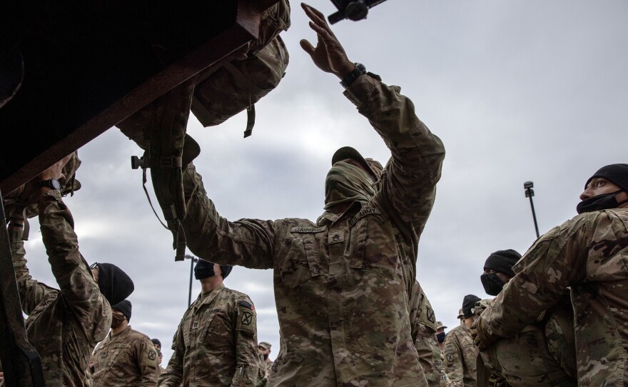 U.S. Army soldiers retrieve their duffel bags after they returned home from a 9-month deployment to Afghanistan on December 10, 2020 at Fort Drum, New York. Earlier this month, President Biden announced that the U.S. would withdraw all its troops from Afghanistan by Sept. 11, 2021