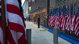 New York City firefighters stand at attention in front of a memorial on the side of a firehouse adjacent to One World Trade Center and the 9/11 Memorial site during ceremonies commemorating the 18th anniversary of the 9/11 terrorist attacks in New York on Wednesday, Sept. 11, 2019. 