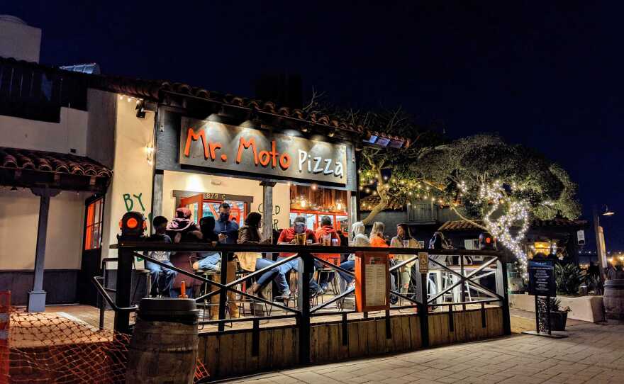 Patrons dining outside Mr. Moto Pizza in SeaPort Village on Jan. 1, 2021, in violation of the regional stay-at-home order.