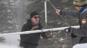 Natural Resources Conservation Service snow surveyors Mike Ardison (left) and Karl Wetlaufer use an aluminum tube to take manual measurements of snowpack on Colorado's Berthoud Pass, Jan. 9, 2018.  