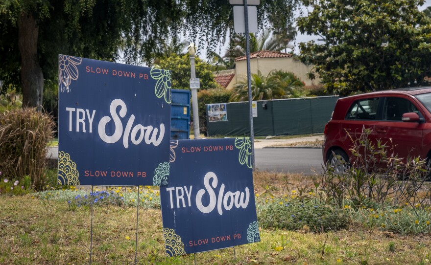 Signs in a front yard on Diamond Street ask drivers to "Slow Down PB," June 19, 2023.