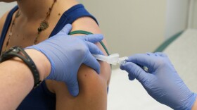 Marisa Grunder, 27 of Wilton, Iowa, is given a shot during trials of an H1N1 vaccine at the University of Iowa Health Center on August 11, 2009 in Iowa City, Iowa. 