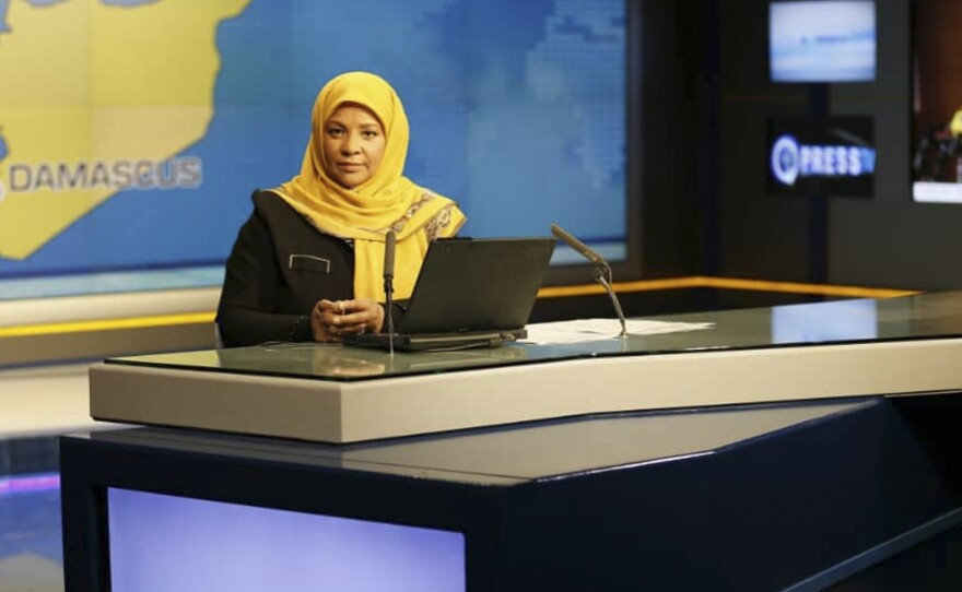 American-born news anchor Marzieh Hashemi sits in a studio in Tehran, Iran. Her eldest son said Wednesday that she was detained on Sunday and is being held without charge.