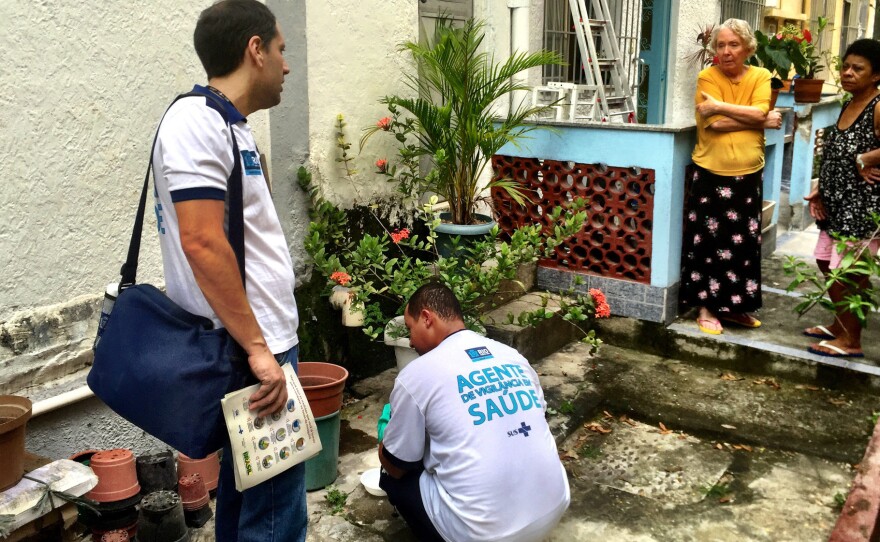 Health inspectors collect samples of mosquito larvae from standing water in a garden in a middle class neighborhood in the north of Rio de Janeiro. They are searching for places where the Aedes aegypti mosquito breeds — that's the one that carries Zika virus.