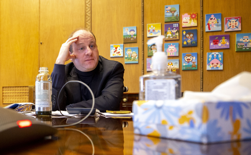 Colorado Gov. Jared Polis listens in to a call with governors around the country, President Trump and Vice President Mike Pence on March 19.