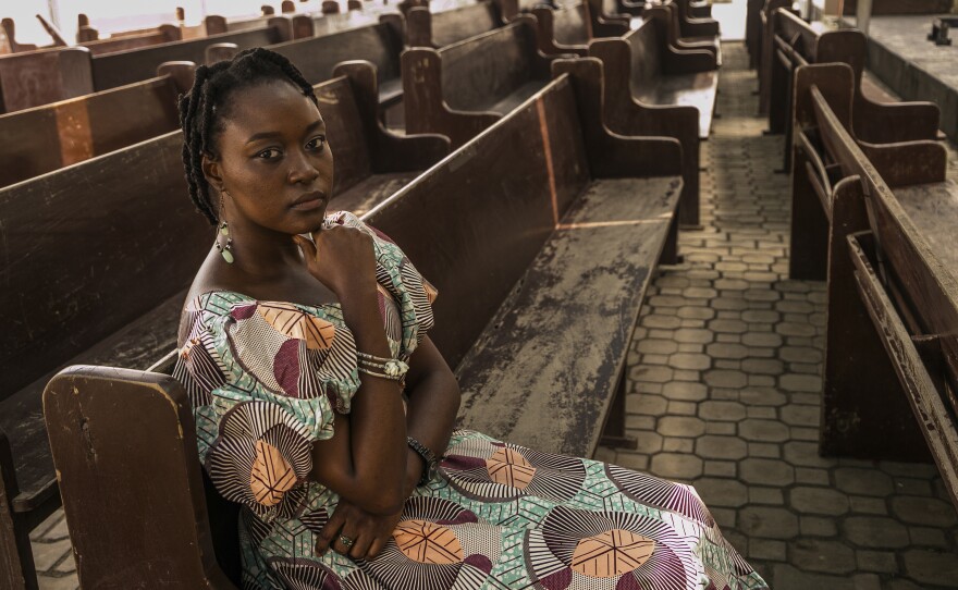 Dr. Henang Kwasau, 30, sits in the church where she's found lodging during her internship at a hospital in Lagos, Nigeria. The photo was taken on February 21, 2021.