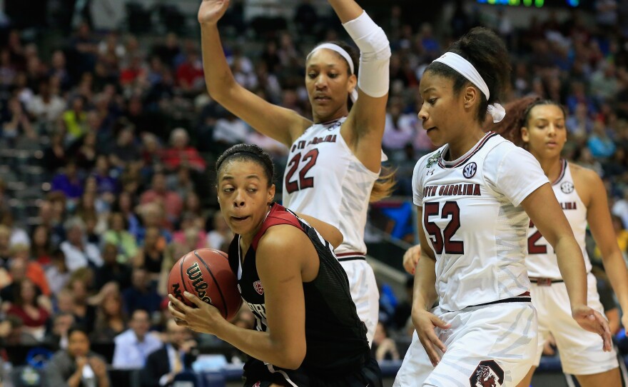 Erica McCall of the Stanford Cardinal drives against Tyasha Harris and A'ja Wilson of the South Carolina Gamecocks in the second half Friday during the semifinal round of the 2017 NCAA Women's Final Four in Dallas.