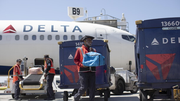 Delta Air Lines ramp agent Mike Davis prepares to load passenger luggage on his cart while working at Hartsfield-Jackson Atlanta International Airport, on May 13, 2026.
