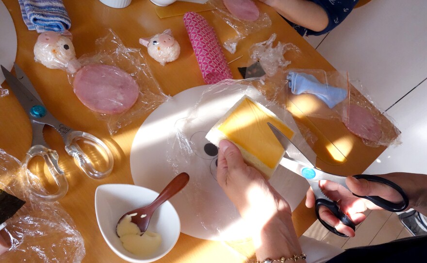 At a class outside Tokyo, Japanese moms learn how to fashion a ham and cheese sandwich into small flower.