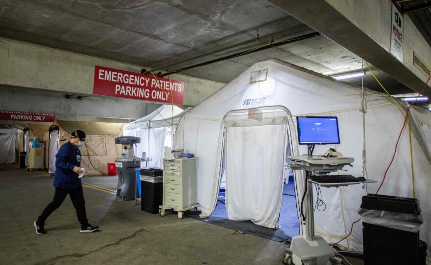 A nurse walks inside a temporary Emergency Room, built into a parking garage at Providence Cedars-Sinai Tarzana Medical Center in Tarzana, California on January 3, 2021. Since Thanksgiving, cases have risen to the point where 80% of the hospital is filled with patients with Covid-19, and 90% of the ICU is now filled with Covid-19.