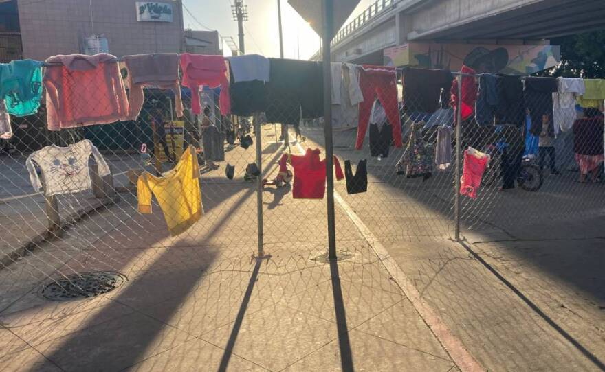 Clothes hang to dry on a fence surrounding a migrant encampment just feet from the U.S.-Mexico border in Tijuana in this undated photo.