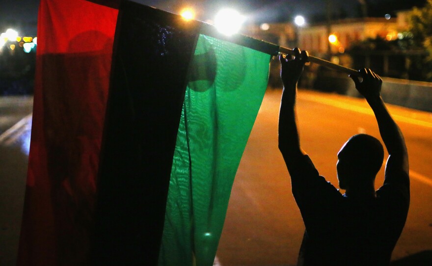 Demonstrators hold up a Pan-African flag to protest the killing of teenager Michael Brown on Aug. 12, 2014 in Ferguson, Mo.