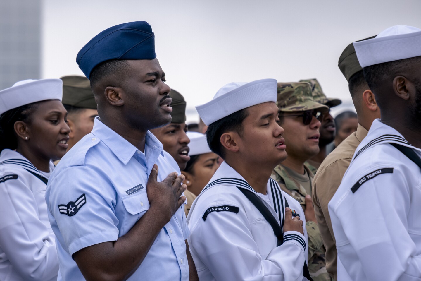 U.S. military members stand in uniform during their naturalization ceremony, July 3, 2023.