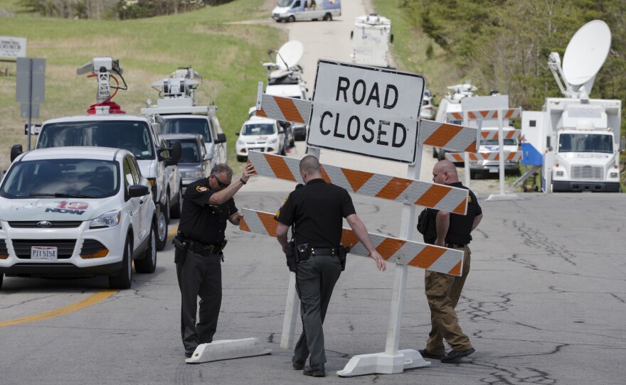 Authorities set up road blocks at an intersection at the perimeter of a crime scene, on Friday in Pike County, Ohio.