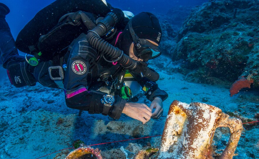 Professional technical diver Gemma Smith studies artifacts on the Antikythera shipwreck.