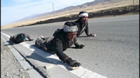 Pilgrims prostrate themselves along a highway near Qinghai Lake. These young Tibetan men say they have no Chinese friends.