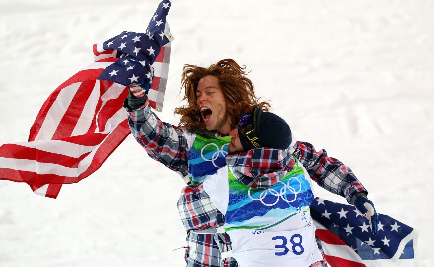 White celebrates with a teammate after he won the gold medal in the men's halfpipe final at the Vancouver 2010 Winter Olympics.