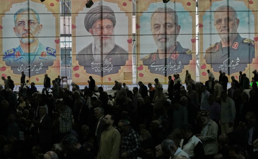 Iranian worshippers perform their Friday prayers under the portraits of the late Iranian Supreme Leader Ayatollah Ali Khamenei, second left, and top military officials who were killed during the U.S.-Israel campaign, at the Tehran University campus, in Tehran, Iran, Friday, April 24, 2026.