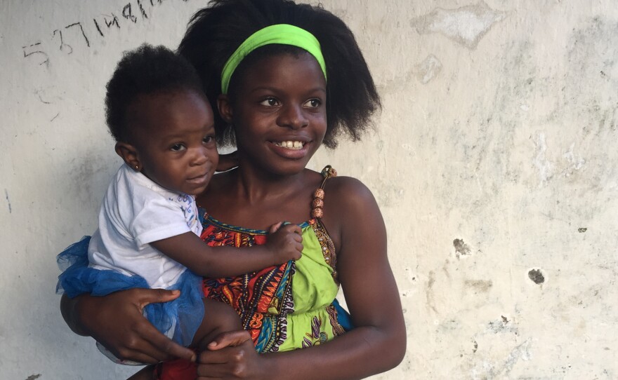 Evelyn Sokpo with Denise, her neighbor's baby.