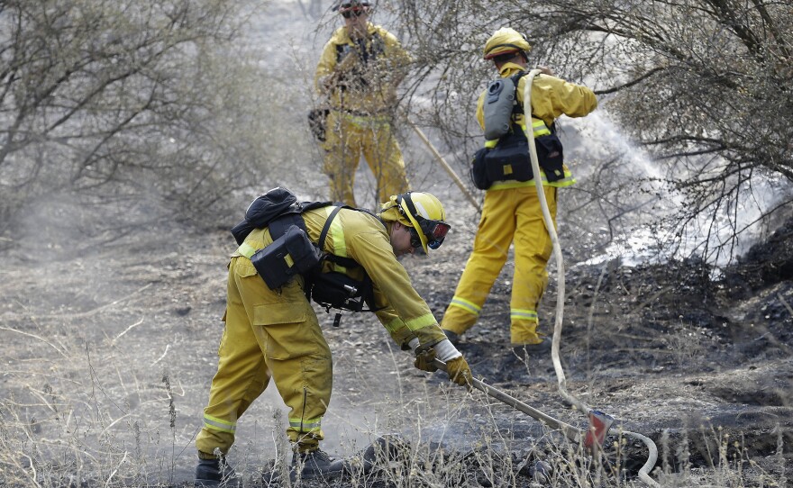 Western firefighters will be getting help from the U.S. Army for the first time in nine years. Which fire the soldiers will fight has not been announced. In this photo, Sonoma Valley Firefighters put out a hot spot from the Rocky Fire near Clearlake, Calif., earlier this month.