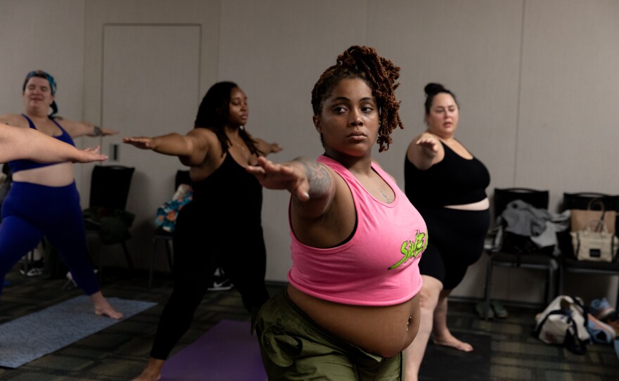 Queen Nzinga (center) during the breathe and flow yoga class at Philly FatCon in October. The class started with breathing exercises while instructor Laura Zales spoke to attendees about taking up space.