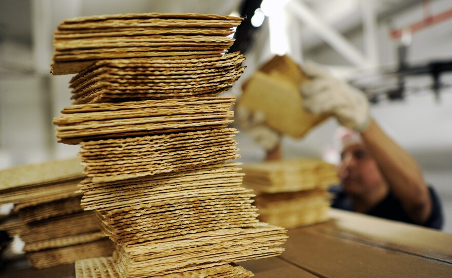 A worker stacks matzo wafers at Streit's matzo factory on the Lower East Side of New York, May 2012.