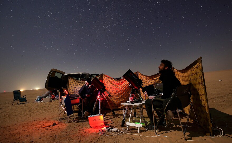 Kuwaiti photographers follow the alignment between Jupiter and Saturn in al-Salmi district, a desert area about 75 miles west of Kuwait City, on Monday.