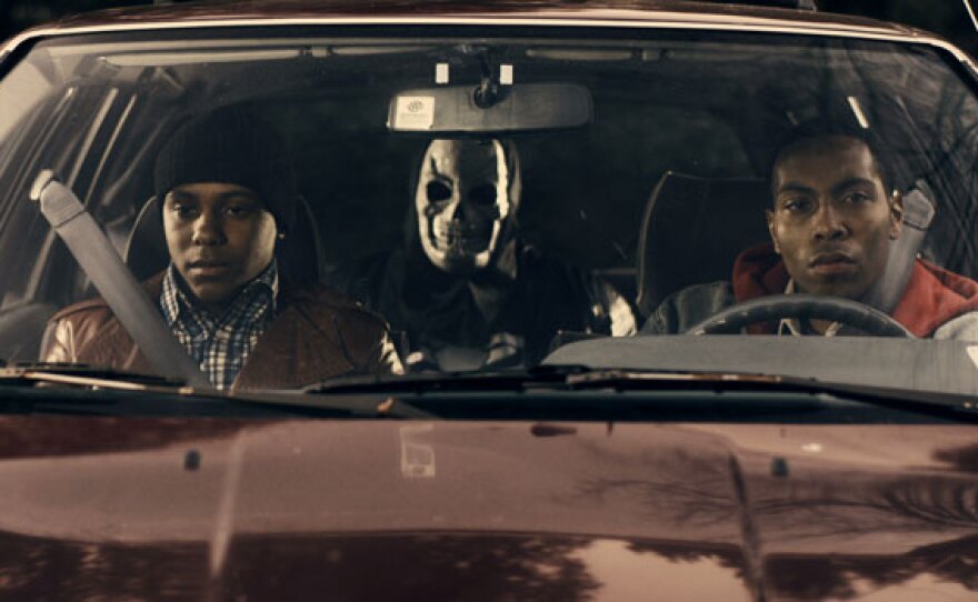 Still from film’s reenactment of Darius Monroe and accomplices preparing to rob a bank.