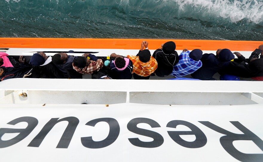 Migrants wait to disembark from the rescue ship Aquarius in the Sicilian harbor of Catania, Italy, on May 27. This past weekend the ship picked up more migrants, but was turned away from ports in Sicily and the nearby country of Malta. Now it will head for Spain instead.