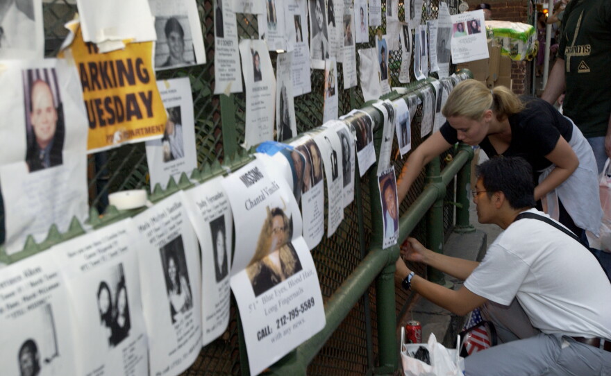 Friends and family members of people missing after the 9/11 terrorist attacks post signs with photos and descriptions outside the Lexington Avenue Armory in New York City on Sept. 13, 2001.