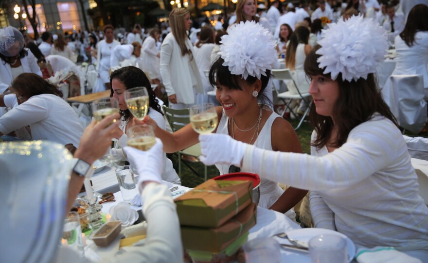 At Diner en Blanc ("Dinner in White"), people arrive dressed all in white. They bring their own food and, fittingly,Β white wine.