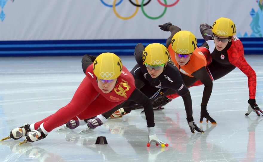 U.S. skater Jessica Smith, in black, is among the Americans who have been kept off the podium in Sochi despite strong performances leading up to the Winter Games. Smith's private coach is Jae Su Chun, who is under a two-year suspension from the International Skating Union.