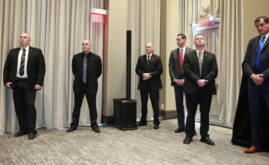 Security personnel look on during the Feb. 28 ceremony opening the Vancouver Trump International Tower and Hotel.