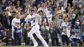 Los Angeles Dodgers' Manny Machado watches his single against the Boston Red Sox during the sixth inning in Game 3 of the baseball World Series in Los Angeles, Oct. 26, 2018. 