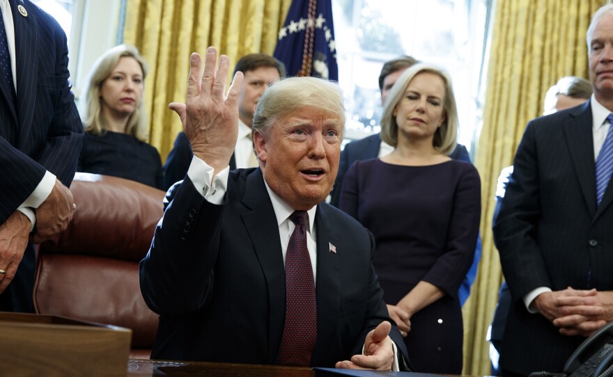 President Trump answers a reporter's question about special counsel Robert Mueller's investigation during a bill signing ceremony Friday in the Oval Office.