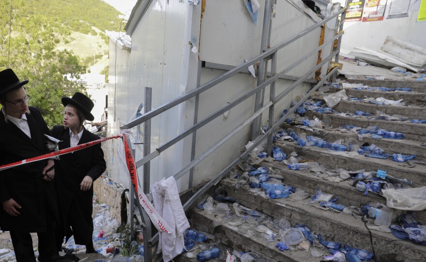 Ultra Orthodox Jews look at the scene where dozens of people were killed and some 150 injured in a stampede during the Lag BaOmer festival at Mt. Meron in northern Israel on Friday.